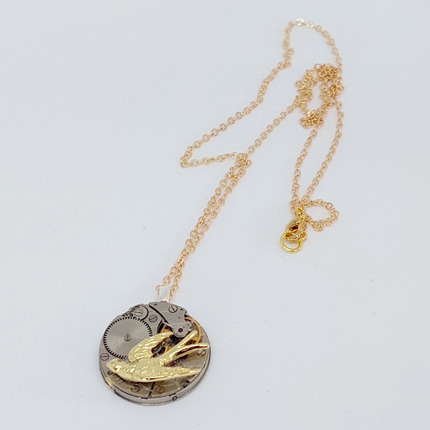 Timepiece Pendant with Golden Swallow