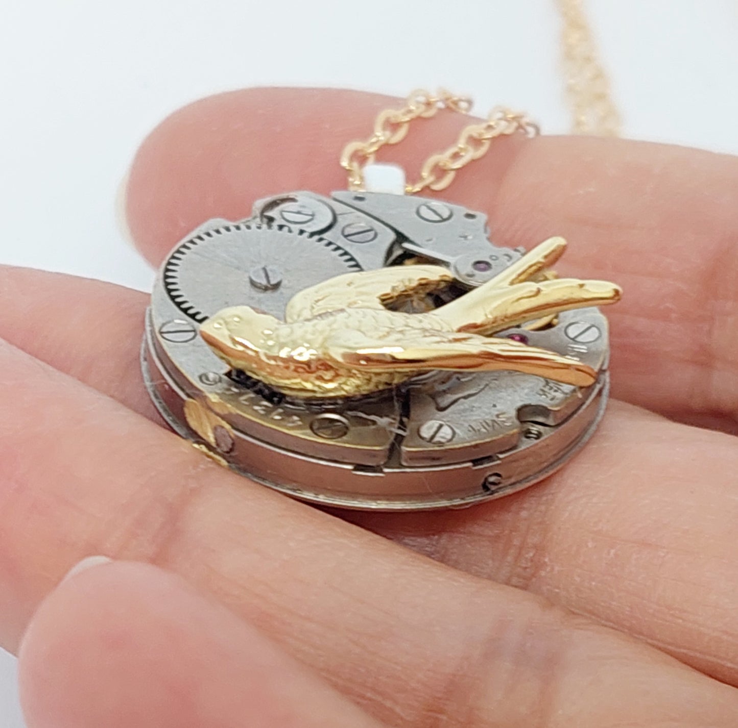 Timepiece Pendant with Golden Swallow