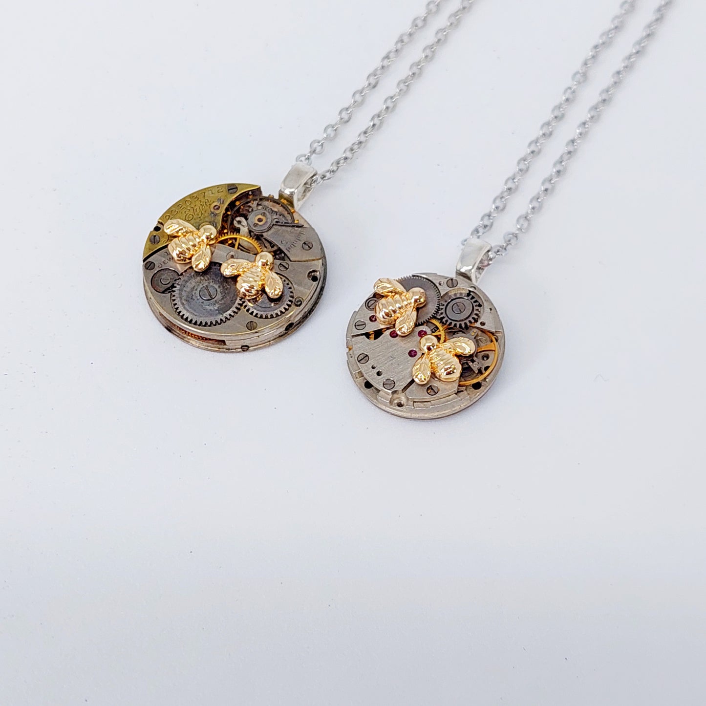 Mini timepiece pendant with tiny golden bees